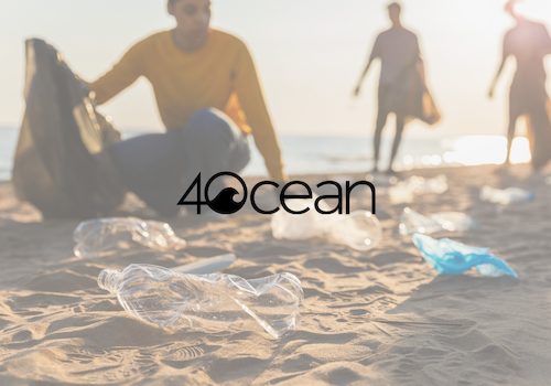 People cleaning plastic waste on a beach with the 4Ocean logo in the foreground, highlighting environmental conservation efforts.